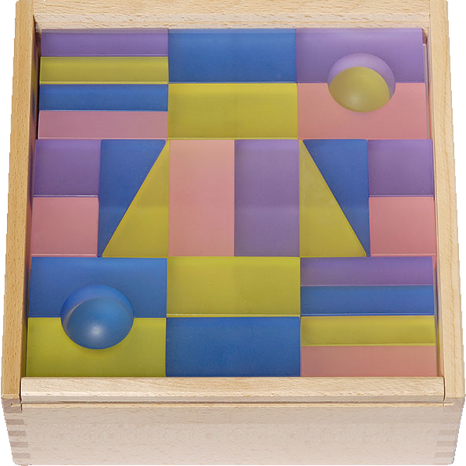 Transparante blokken pastel in een houten kist